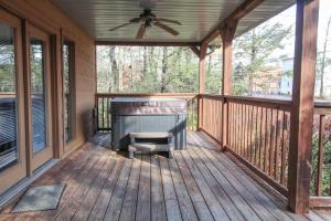 a screened porch with a piano and a ceiling fan at Mountain Dew - 2 Bedrooms, 2 Baths, Sleeps 4 cabin in Gatlinburg