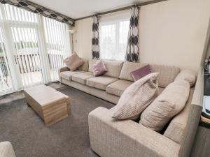 a living room with a couch and a table at Flower Stone in Morpeth