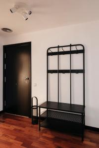 a black shelf in a room with a door at TSA Sepulveda in Barcelona