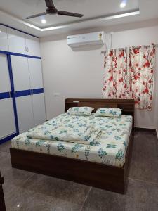 een slaapkamer met een bed en een plafondventilator bij New Premium Fully Furnished 2 BHK Flats Near Station in Tirupati