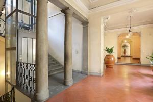 an empty hallway with columns and a staircase at Lemon Tree One Bedroom with Balcony in Florence