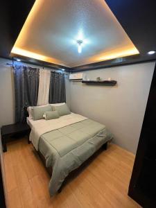 a bedroom with a large bed in a room at One Oasis Condo 2 Bedroom Free Pool & Wifi Beside SM City Mall in Davao City