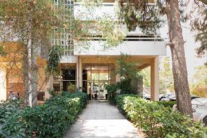 a building with a walkway in front of it at Radiant 2BR Apartment in Neo Psichiko by UPSTREET in Athens