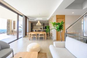 a living room with a table and a dining room at Dobo Marbella Bermeja in Estepona +28 photos