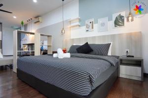 a bedroom with a large bed with a teddy bear on it at Lily and Loft - Queensville @ Kuala Lumpur - Netflix in Kuala Lumpur +284 photos