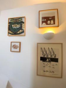 a group of pictures hanging on a wall at Contemporary Eco-Home near Bristol Harbourside in Bristol