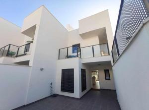 a white house with a staircase and a balcony at Sea Views Villa Benalmádena ComoTuCasa in Benalmádena