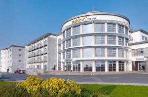 a large white building with a sign on it at Maldron Hotel & Leisure Centre Limerick in Limerick