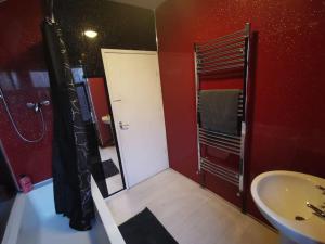 a bathroom with a white door and a sink at 2 bedroom house, Tunstall, Stoke-on-Trent. in Stoke on Trent +23 photos