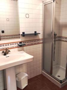 a bathroom with a sink and a shower at Casa Vilanova in A Coruña