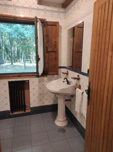 a bathroom with a sink and a window at Casa Vilanova in A Coruña