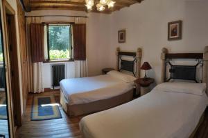a bedroom with two beds and a window at Casa Vilanova in A Coruña