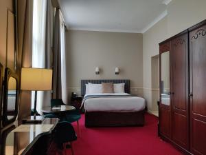 Letto o letti in una camera di Harcourt Hotel