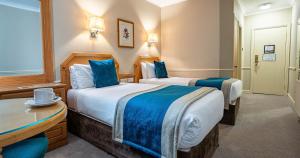 Letto o letti in una camera di Harcourt Hotel