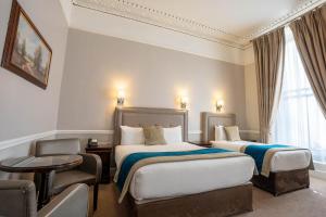 Letto o letti in una camera di Harcourt Hotel