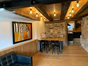 a dining room with a wooden table and chairs at Hausele in Sulzbach an der Murr