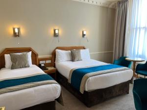 Letto o letti in una camera di Harcourt Hotel