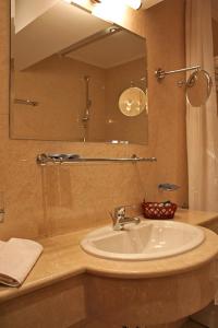 a bathroom with a sink and a mirror at Danube Hotel & Spa in Silistra