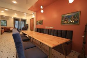 a conference room with a wooden table and chairs at Villa Reverie - Ultra Modern Villa 200 metres to Prestine Beach in Betalbatim +39 photos