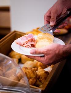 a person holding a plate of food with a knife at Ta' Tereza In Manwel Dimech in Sliema