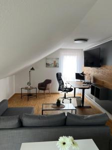 a living room with a couch and a table at New Age Boardinghaus Bad Wimpfen in Bad Wimpfen