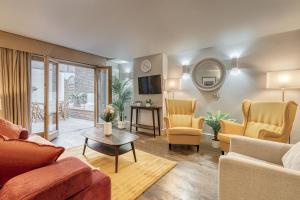 a living room with a couch and chairs and a table at Stay at Piccadilly in London