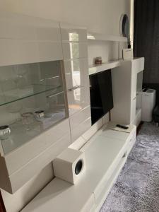 a white cabinet with a tv on top of it at Luxus Apartment in duisburg in Duisburg