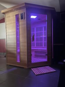 Habitación con ducha con luces moradas. en Suite avec Sauna 36m², en Niort