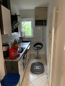 a small kitchen with a sink and a stool in it at Luxus Apartment in duisburg in Duisburg