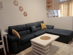 a living room with a blue couch and a table at Exquisite 1br Apartment along Eldoret-Kisumu Road close to Eldoret Polytechnic in Eldoret