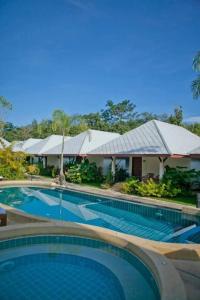 a large swimming pool in front of a resort at Baan Chong Fa Resort in Khao Lak