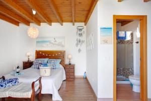 a bedroom with a bed and a bathroom at Vista Tostón in Cotillo