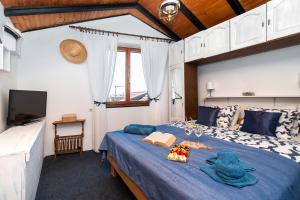 a bedroom with a blue bed with a blue blanket at House Brunac with parking in Vodice