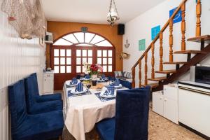 a dining room with a table and blue chairs at House Brunac with parking in Vodice