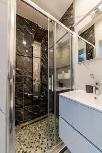a bathroom with a shower and a sink at La Fortezza Panzió in Budapest