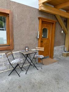 a table and two chairs in front of a building at Appartement Anna in Niederau