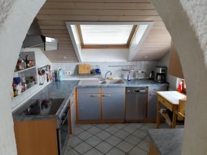 an attic kitchen with a sink and a window at Trochtelfingen F1 in Trochtelfingen
