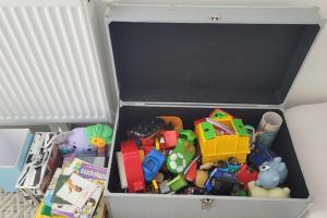 a box filled with toys and books on a table at Maison avec jardin sur Berck in Berck-sur-Mer