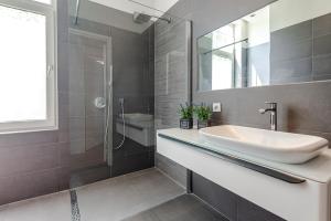 a bathroom with a sink and a shower at Studio Estelle's with Private Parking in Zandvoort