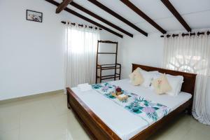 a bedroom with a bed with a wooden frame at le bella1912 in Galle
