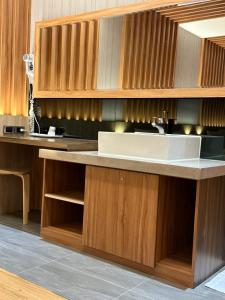a kitchen with a sink and wooden cabinets at Julin Motel in Zhushan