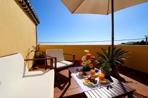 a table with food and drinks on a balcony at Los Nacientes: Marcos in Los Sauces