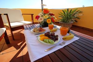 una mesa con dos platos de comida y fruta. en Los Nacientes: Marcos, en Los Sauces