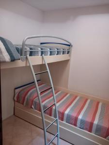a bunk bed with a ladder in a room at La casetta di Lula in Trapani