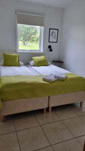 a large bed in a bedroom with a window at Guesthouse Galleri Vík in Vík