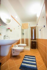 a bathroom with a sink and a toilet and a shower at La casetta di Lula in Trapani