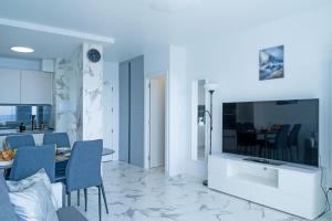 a living room with a large television and a table at Club Paraiso 1306 in Playa Paraiso