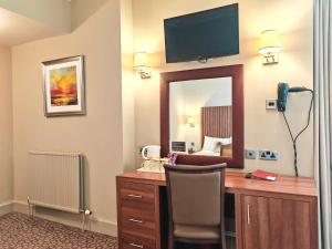 a hotel room with a desk and a mirror at Frederick House Hotel in Edinburgh
