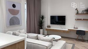 a living room with a couch and a tv at Boulevard 46 in Tashkent