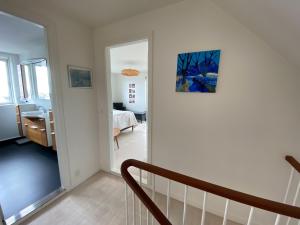 a room with a staircase leading to a bedroom at 1 Bedroom Home - Private Balcony - Parking On Site in Tórshavn